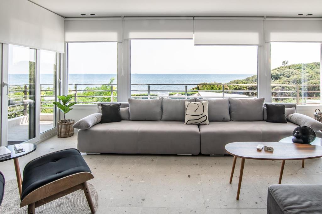 a living room with a couch and a view of the ocean at Villa Mare in Makri