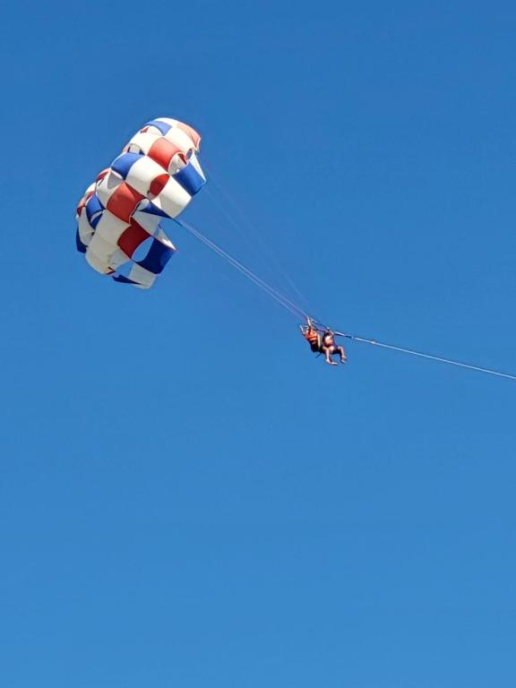 a kite flying in the blue sky at Lido Jinen Hammamet in Hammamet