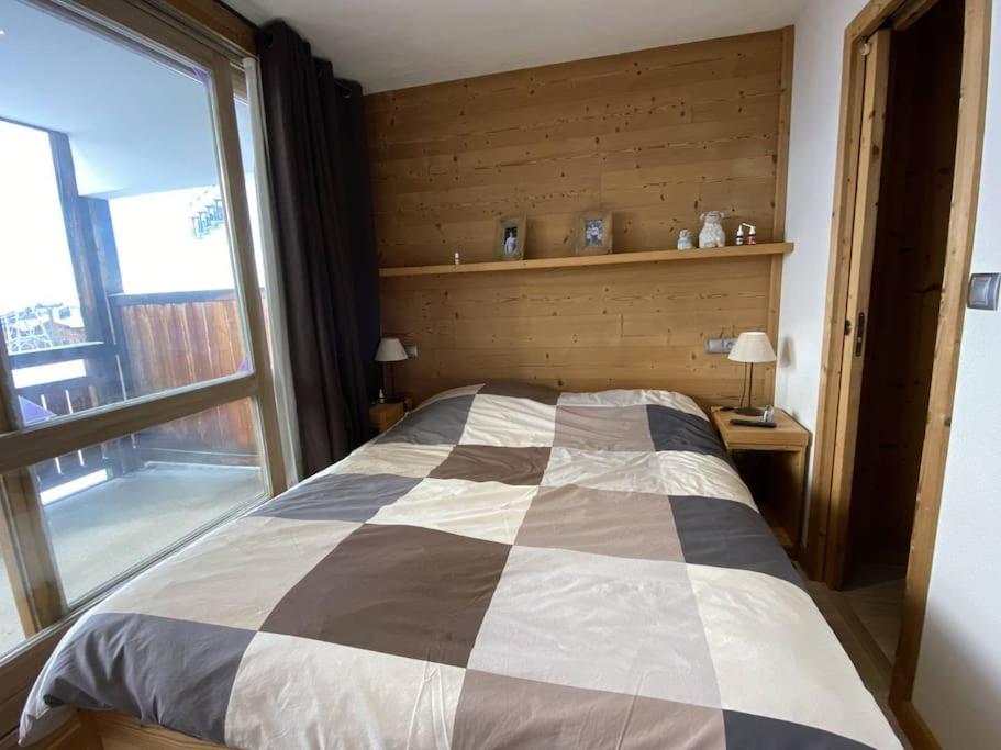 a bedroom with a bed with a large window at Alpe d&#39;Huez Houses - Chalet des Roches - Duplex, SUR les pistes de 3 chambres ! in LʼHuez