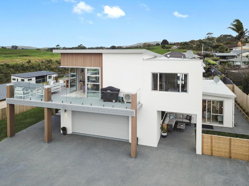 an aerial view of a white house at Hillside Haven House & Unit in Raglan