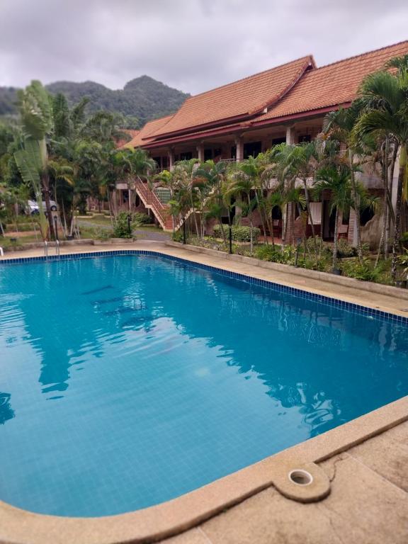 a large blue swimming pool in front of a building at Sofia Garden Resort in Ko Chang