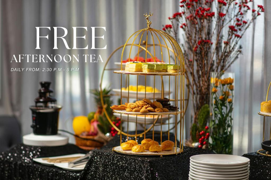 a black table topped with a bird cage with food at Lucien Hanoi Lakeside Hotel & Rooftop in Hanoi