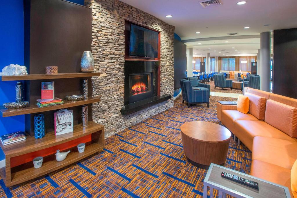 a lobby with a couch and a fireplace at Courtyard by Marriott Montgomery Prattville in Prattville