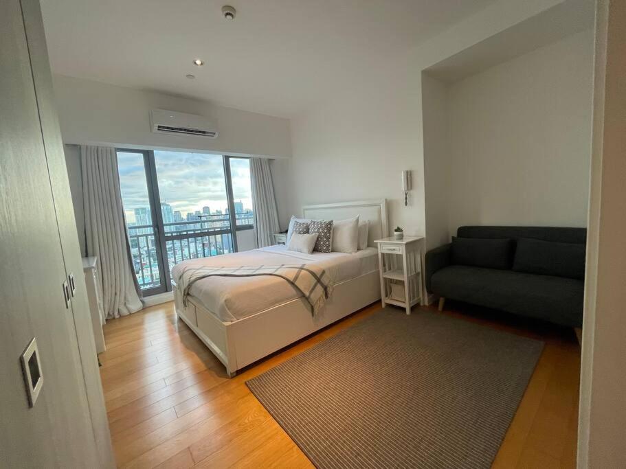 Ένα ή περισσότερα κρεβάτια σε δωμάτιο στο Aveline Suites Aesthetic Skydeck View ACQUA Private Residences near Rockwell Makati