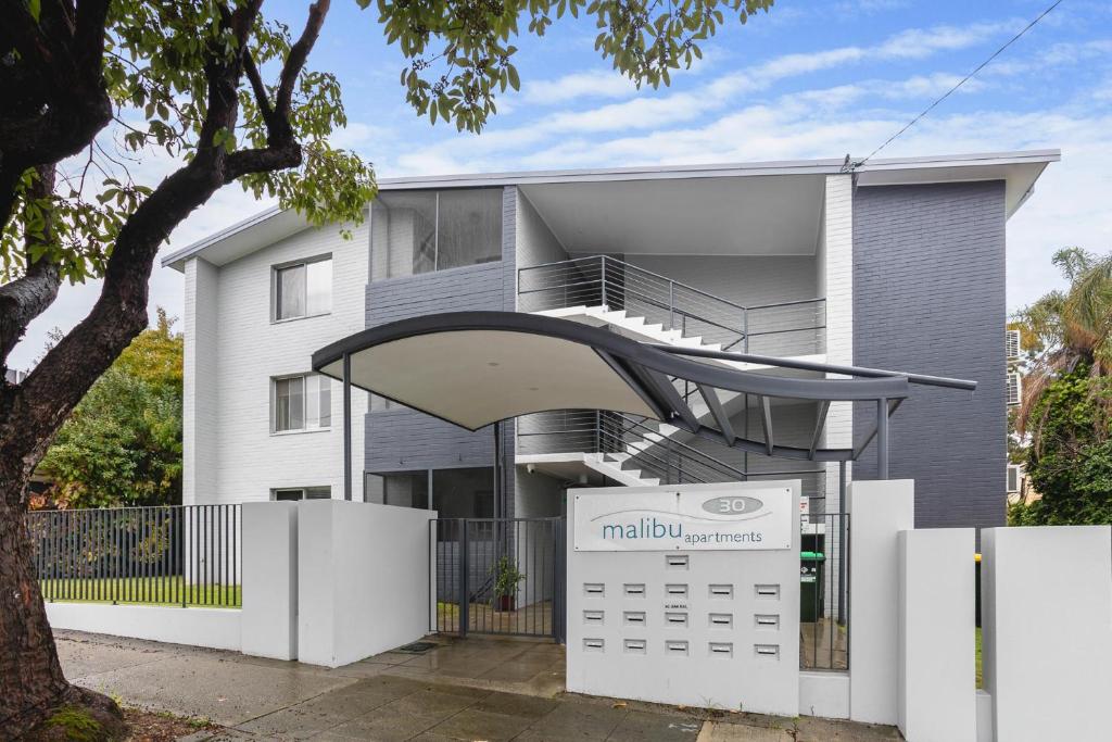 a house with a staircase and a calendar in front of it at Malibu Apartments - Perth in Perth