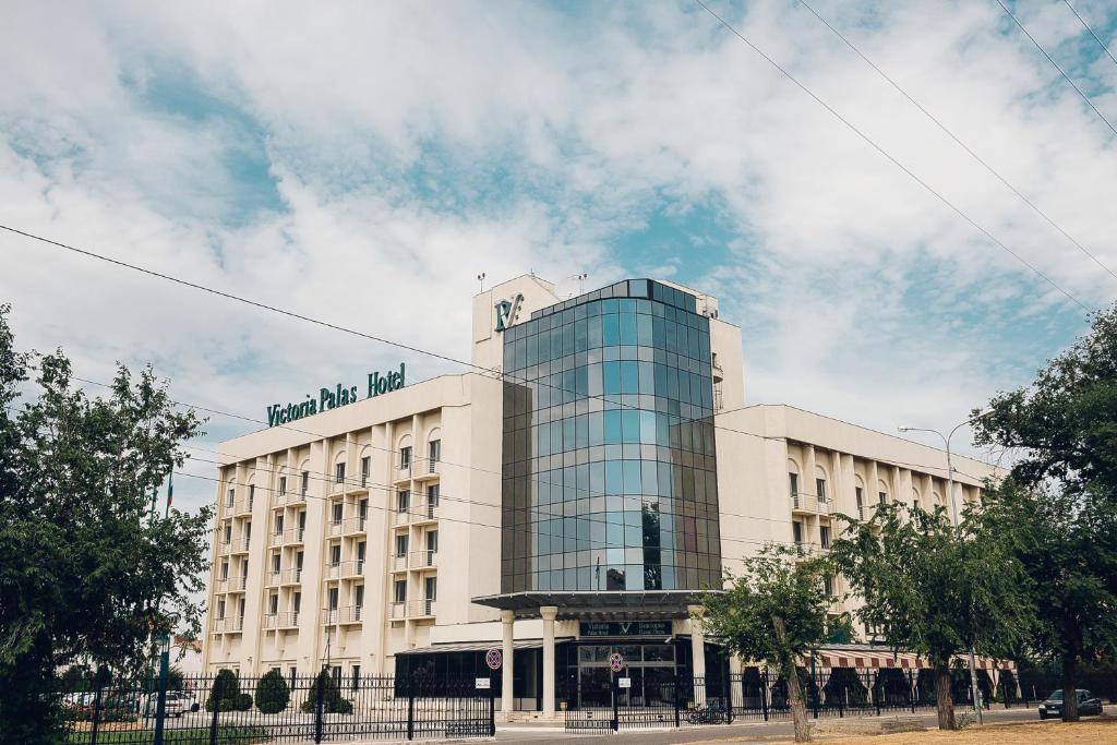 a building with a sign on top of it at Victoria Palas Hotel in Astrakhan