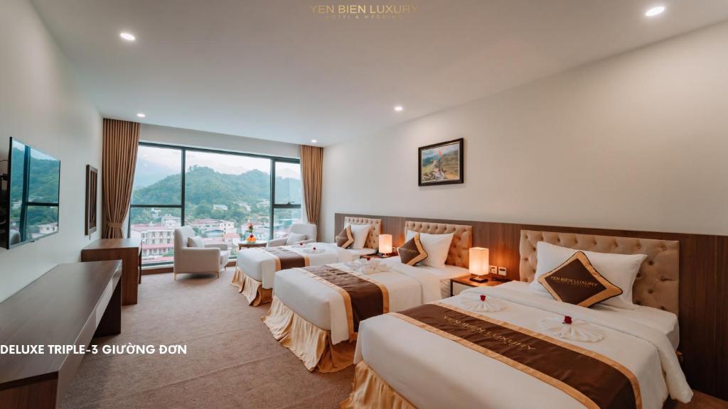 Giường trong phòng chung tại YEN BIEN LUXURY HOTEL