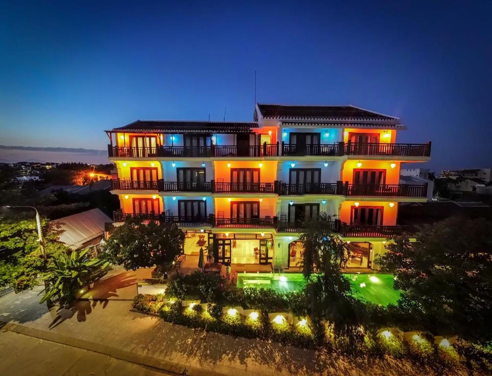 un gran edificio con luces encendidas por la noche en Hoi An Odyssey Hotel & Spa, en Hoi An