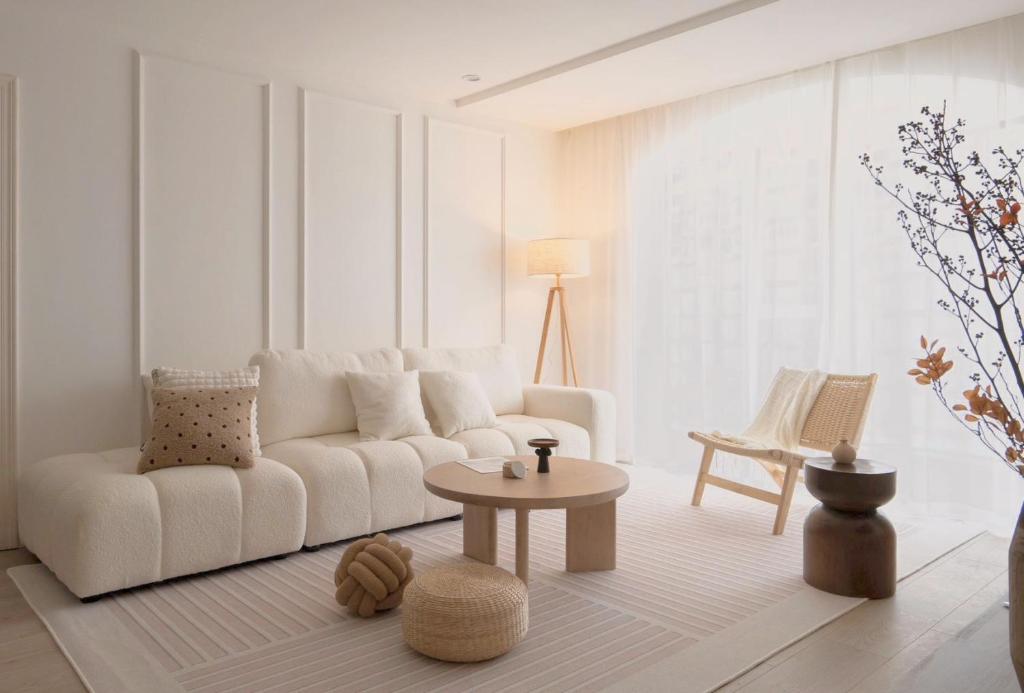 a living room with a white couch and a table at Sun Wonderland Apartment - Near The Bund in Shanghai