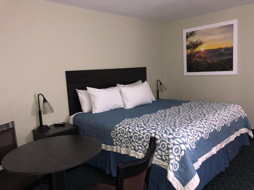 a hotel room with a bed and a table at Elevation Lodge in South Lake Tahoe