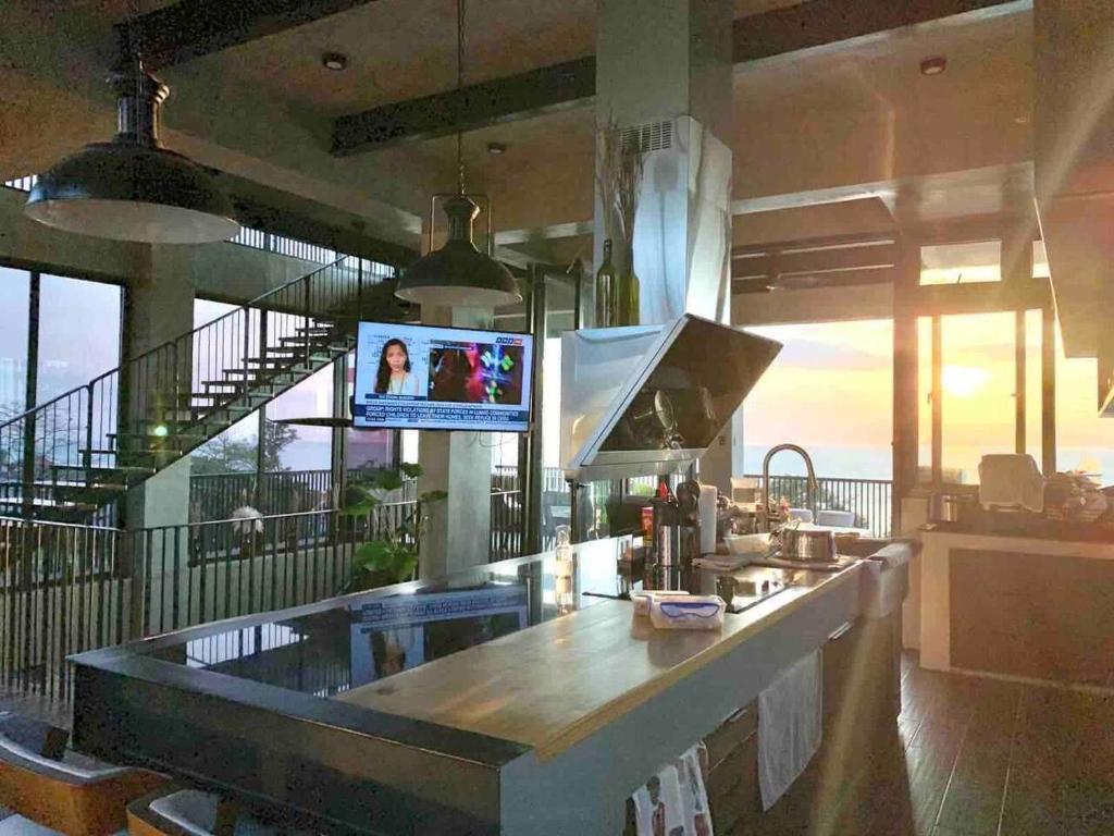 a kitchen with a counter with a tv in it at Brisa de Cristal at Canyon Cove Nasugbu Batangas in Nasugbu