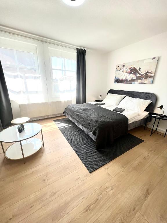 a bedroom with a large bed and a table at Isabellas: Near to trainstation in Linz