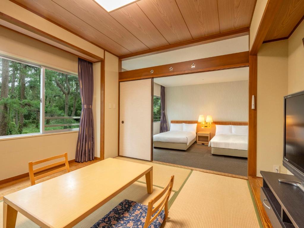 Postel nebo postele na pokoji v ubytování KAMENOI HOTEL Kamogawa
