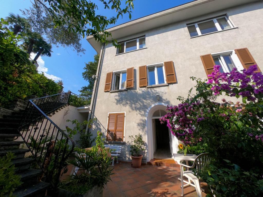 a house with stairs and flowers in front of it at Easy Stay by Hotel La Perla in Ascona