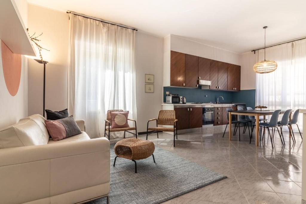 a living room and kitchen with a couch and a table at A Tutto Tondo Apartment - Comfort and Style in Lerici in Lerici