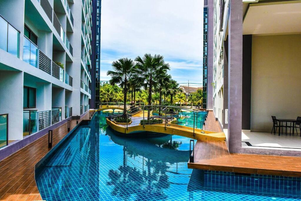 a swimming pool with a slide in a building at Laguna Beach Resort 1 by BPS in Jomtien Beach
