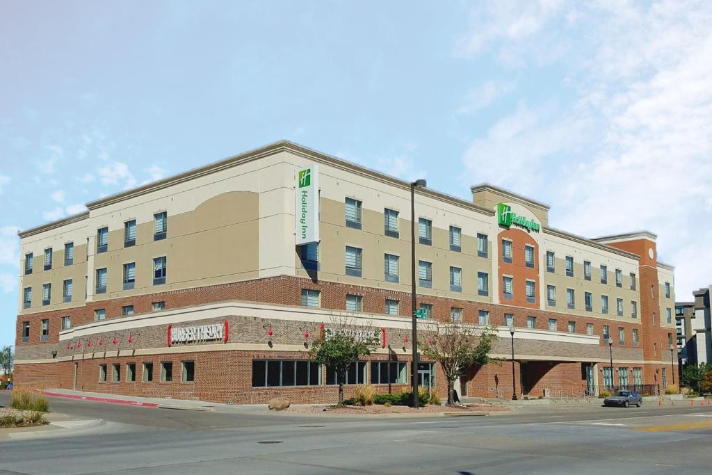 a large building on the corner of a street at Holiday Inn Omaha Downtown - Waterpark, an IHG Hotel in Omaha
