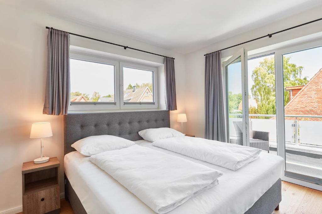 Postel nebo postele na pokoji v ubytování Apartmenthaus Emily by POLY Hohwacht