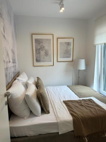 a bedroom with a bed with pillows and a window at Apartments Tenerifa in Novigrad Istria