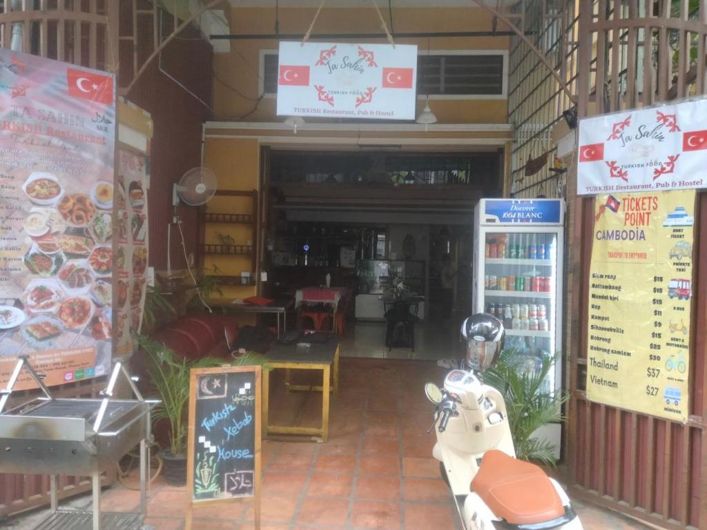 a restaurant with a motorcycle in the front of it at TaSahin Hostel & Turkish Restaurant & Bar in Phnom Penh