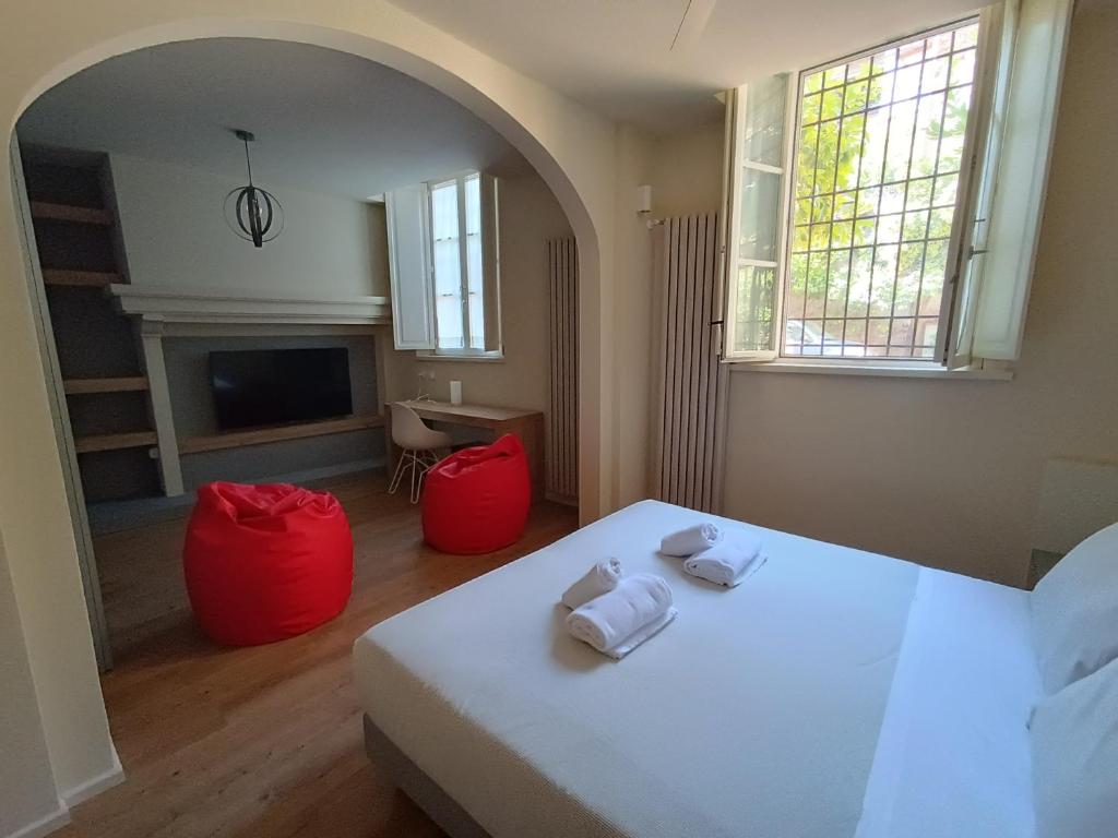 1 dormitorio con 1 cama y 2 reposapiés rojos en Chill in Tuscany ground floor, en Lucca