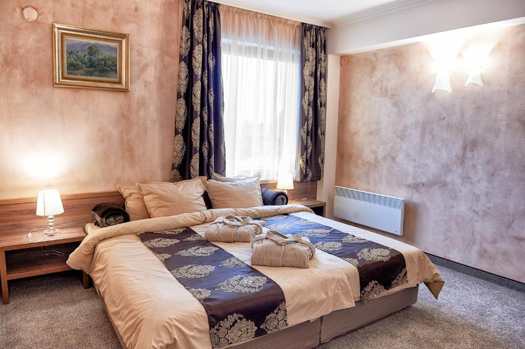 Postel nebo postele na pokoji v ubytování Platinum Image Hotel