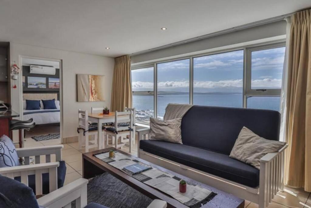 a living room with a couch and a view of the ocean at Nautical views in Mossel Bay