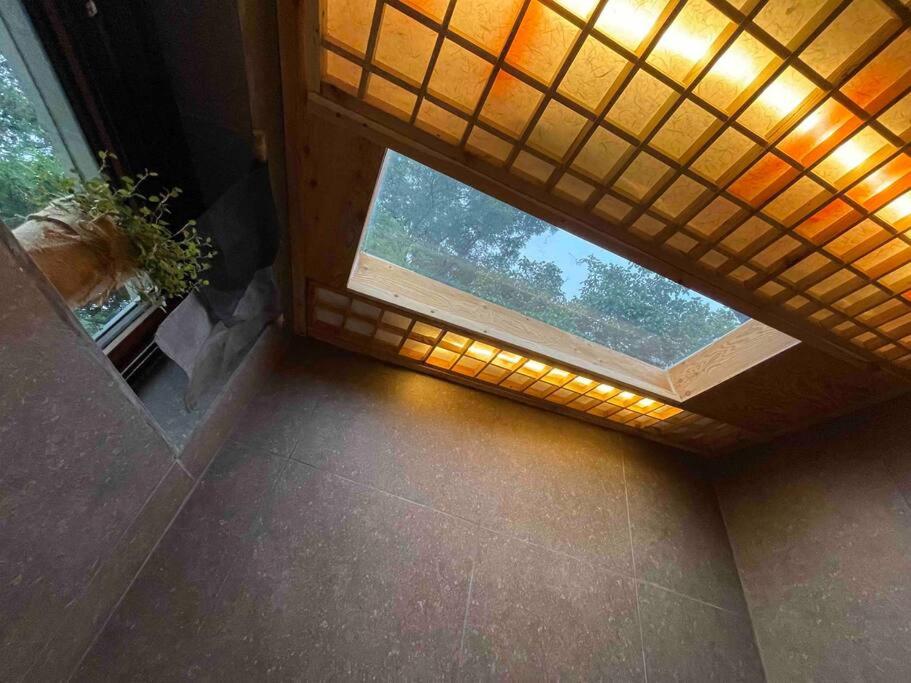a room with a window and a window sill with a plant at Bow Hanok House in Gangneung