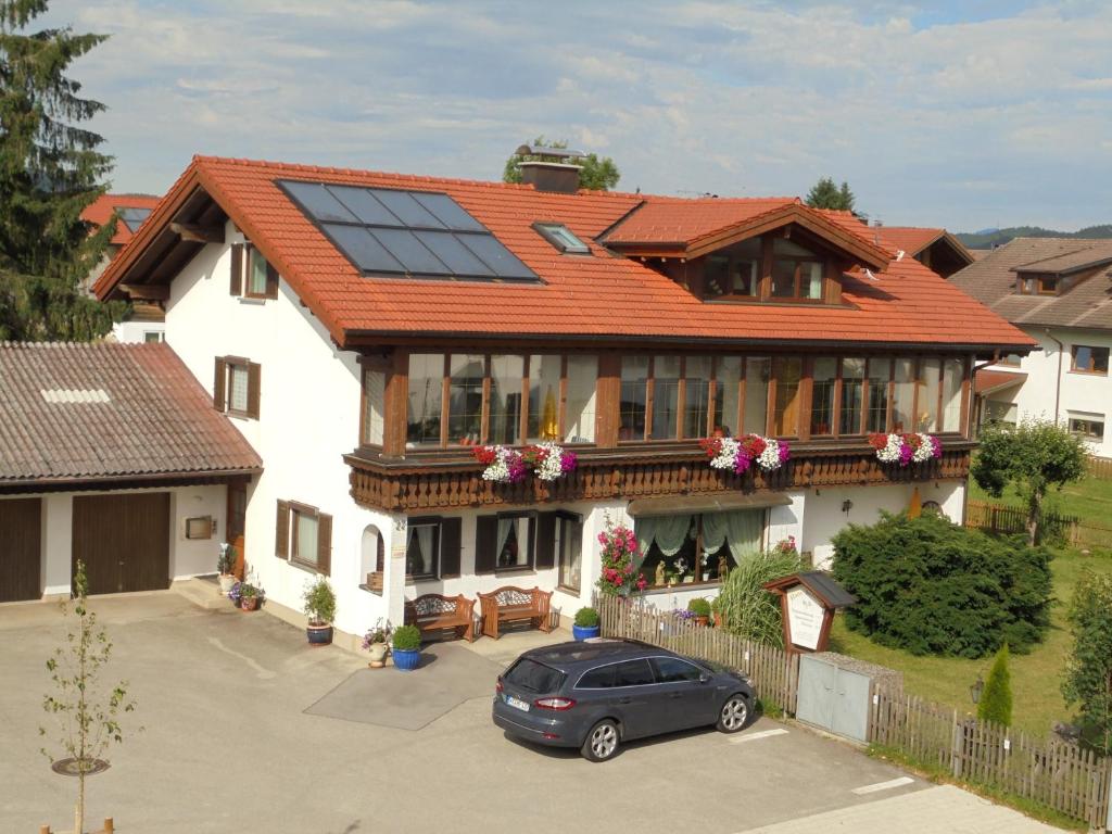 a house with a car parked in front of it at Haus Schmölz Ferienwohnung Allgäu in Hopferau