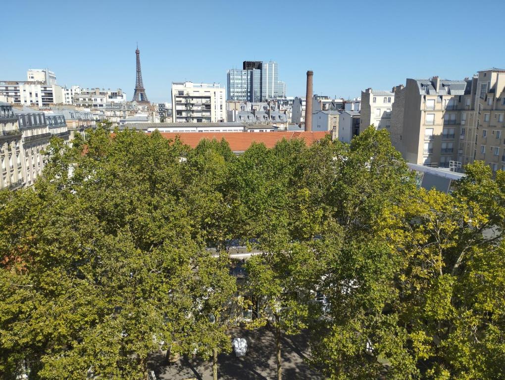 a view of a city with trees and buildings at VOLONTAIRES EIFFEL TOWER PARIS in Paris