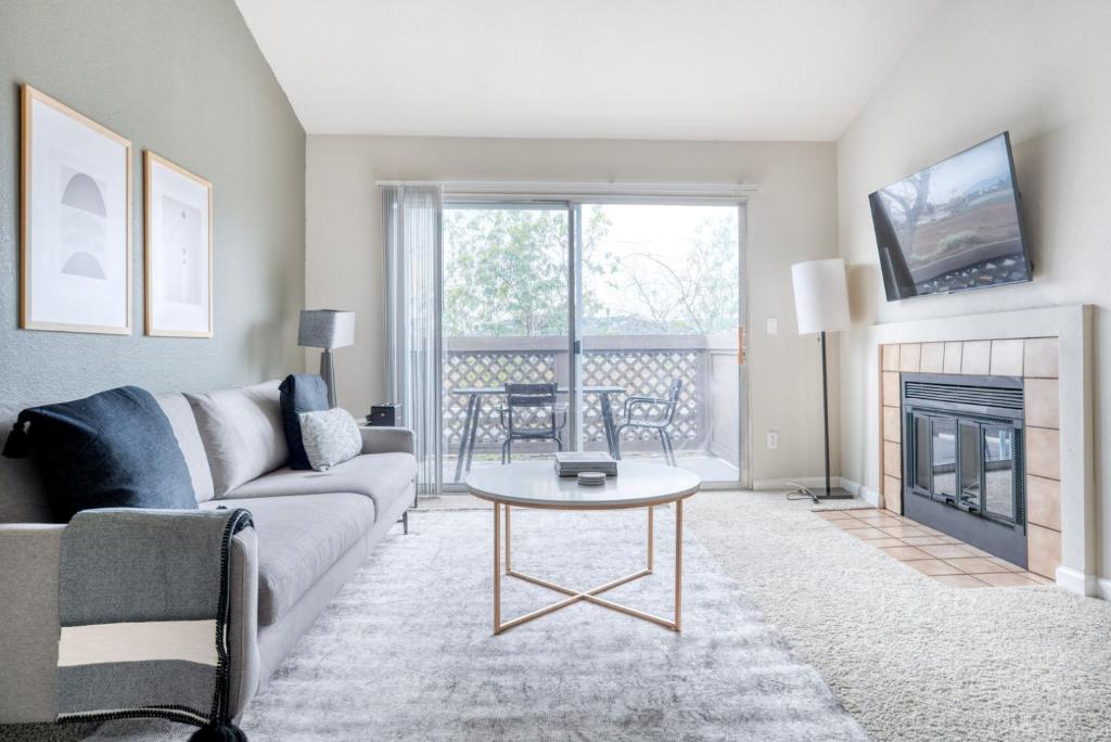 a living room with a couch and a fireplace at Foster City 2br w gym pool wd nr shops SFO-1293 in Belmont