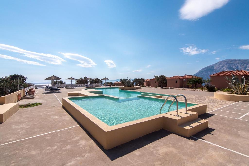 a swimming pool with a view of the mountains at Angela's House in Koumeika