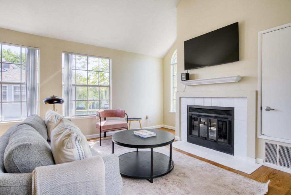 a living room with a couch and a fireplace at Foster City 2BR w Gym 2 Pools WD nr VISA SFO-969 in Foster City
