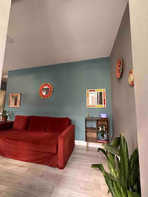 a red couch in a living room with a blue wall at Central London - Edgware Road 2 GF Bedroom Flat in London