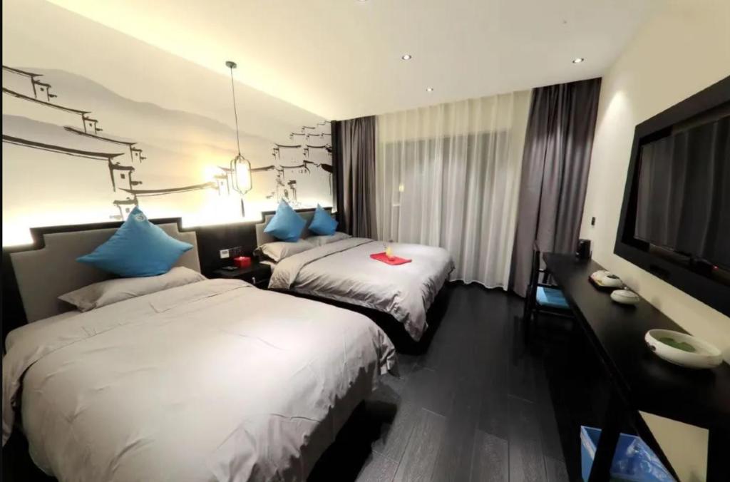 Postel nebo postele na pokoji v ubytování Gongxili - Chujian Hotel