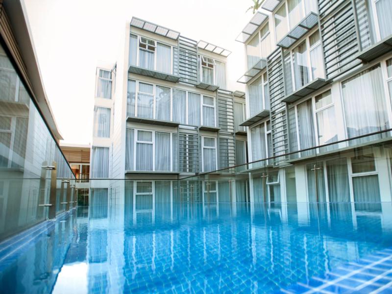 a large building with a swimming pool in front of it at Glenwood Residences in Ho Chi Minh City