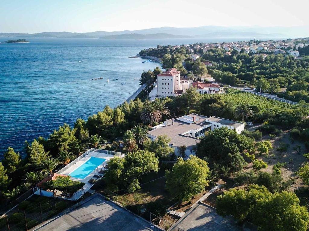 an aerial view of a house and the water at Villa Peljesac Majestic A Beautiful 8 Bedroom Villa Short Stroll Down the Path to the Beach in Orebić