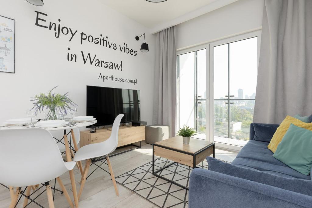 a living room with a blue couch and a table at Pet-Friendly Apartment Prymasa Tysiąclecia by Renters in Warsaw