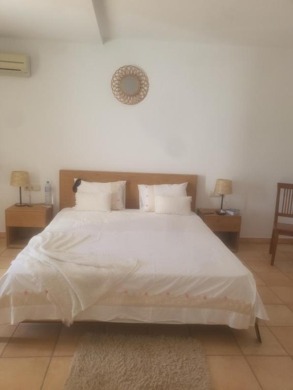 a large white bed with white sheets and pillows at Siesta el por del sol in Santa Eularia des Riu