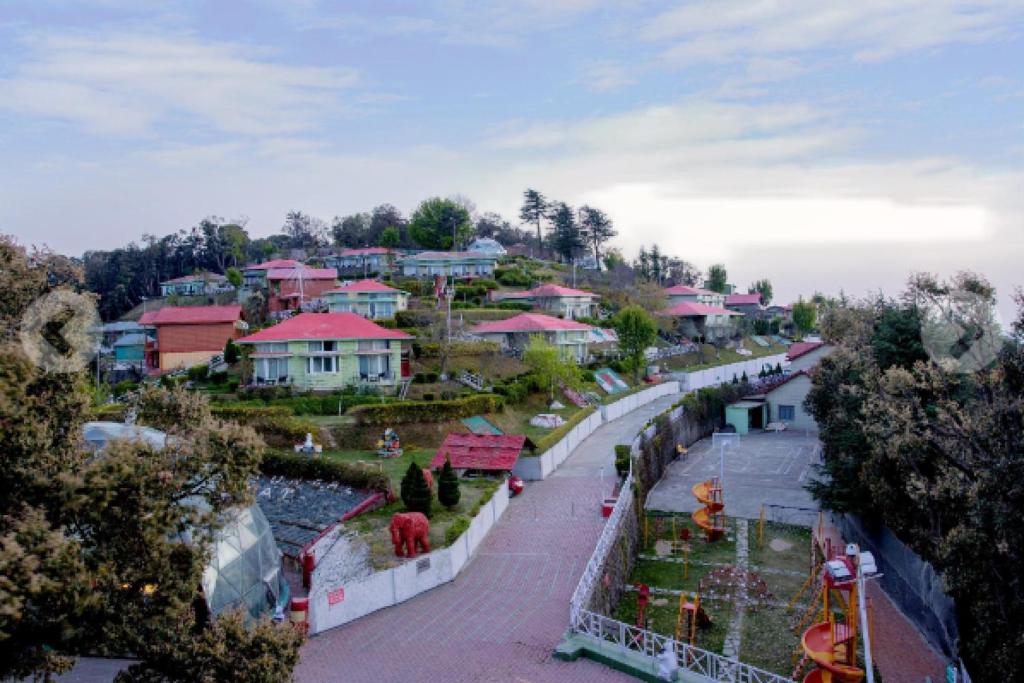 a view of a town with houses on a hill at Tarika Resort & Spa , Chail in Chail