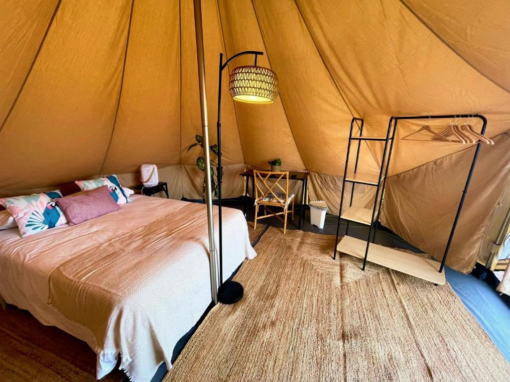 a bedroom with a bed in a tent at Porto Santo Destination in Porto Santo