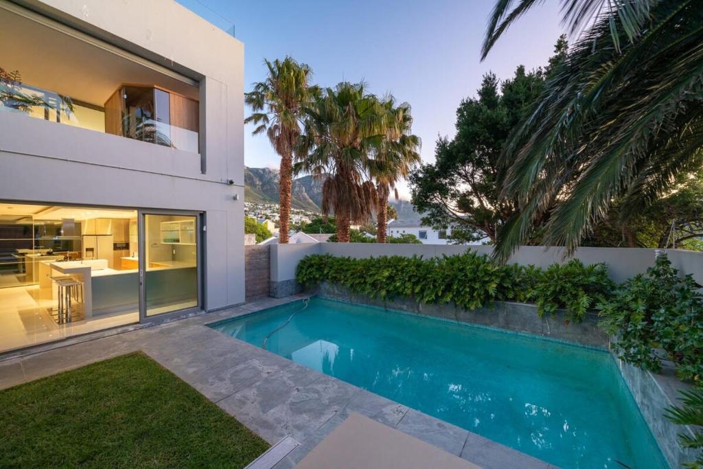a swimming pool in the backyard of a house at Amara Lincoln - 100m From Camps Bay Beach in Cape Town