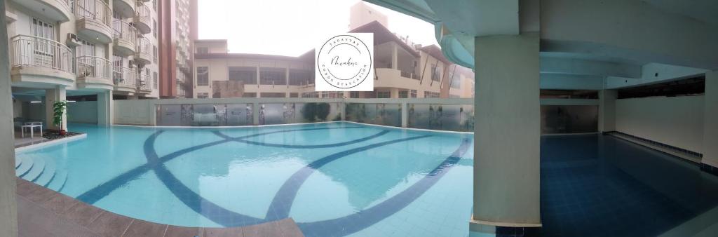 a large swimming pool in the middle of a building at Tagaytay Condo Staycation in Iruhin
