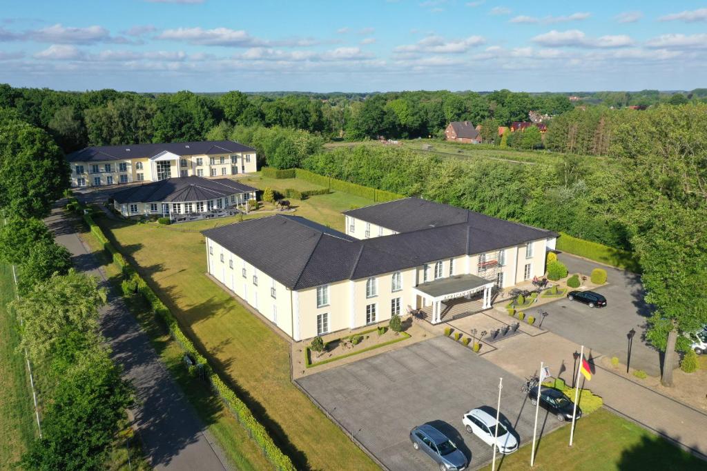 an aerial view of a large white building with a parking lot at African Sky Hotel in Werlte