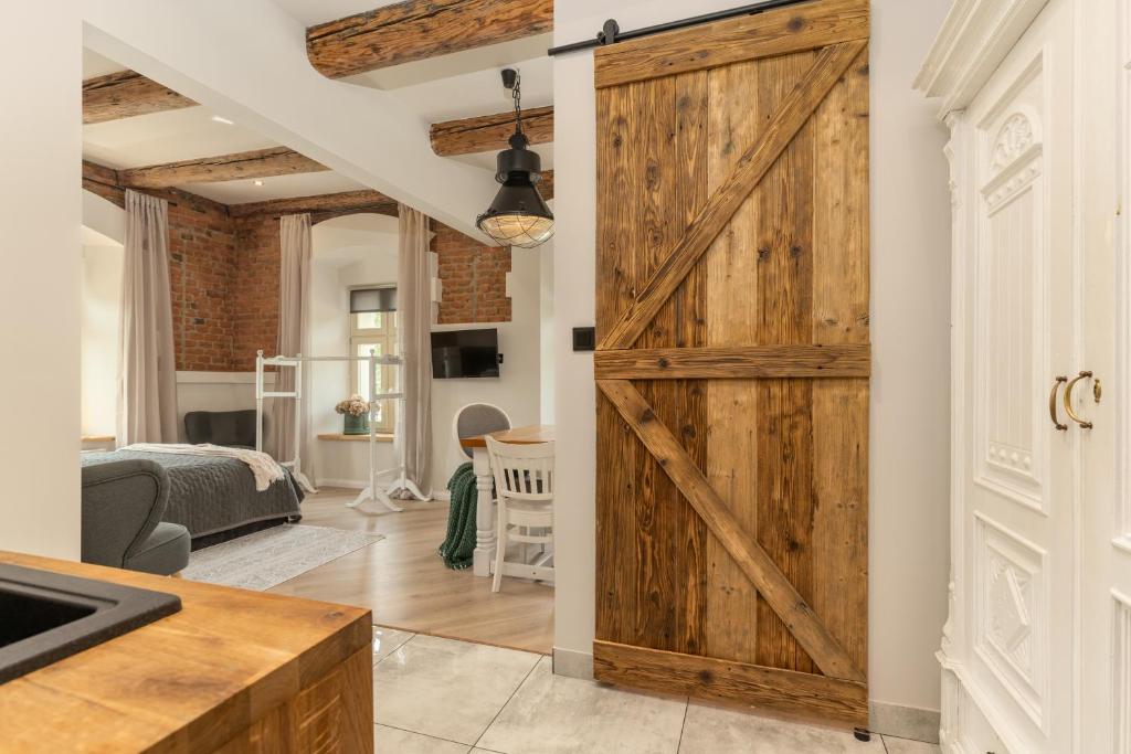 a sliding barn door in a kitchen and living room at PropertiesForYou in Bielsko-Biała