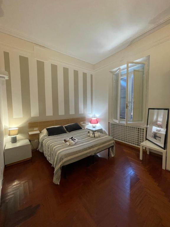 a bedroom with a large bed and a window at Popolo Dream Suites - Luxury Rooms in Rome