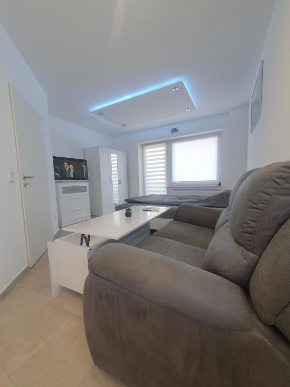 a living room with a couch and a table at Las Vegas Apartment in Paderborn