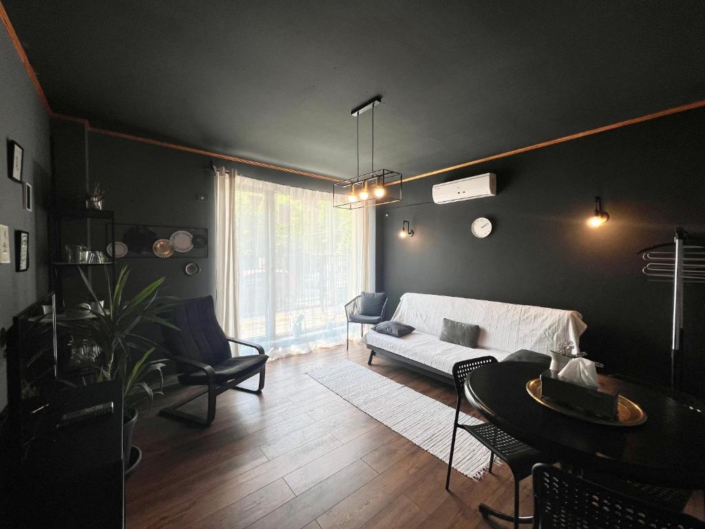 a living room with a couch and a table at INC apartment in villa in Bucharest