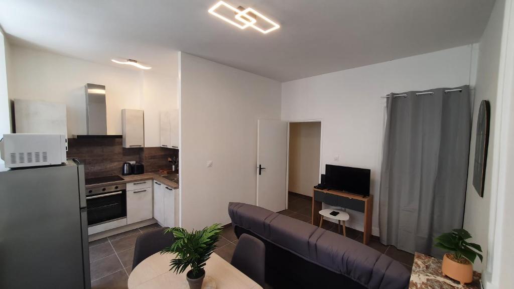 un salon avec un canapé et une cuisine dans l'établissement Le cœur Montilien, à Montélimar