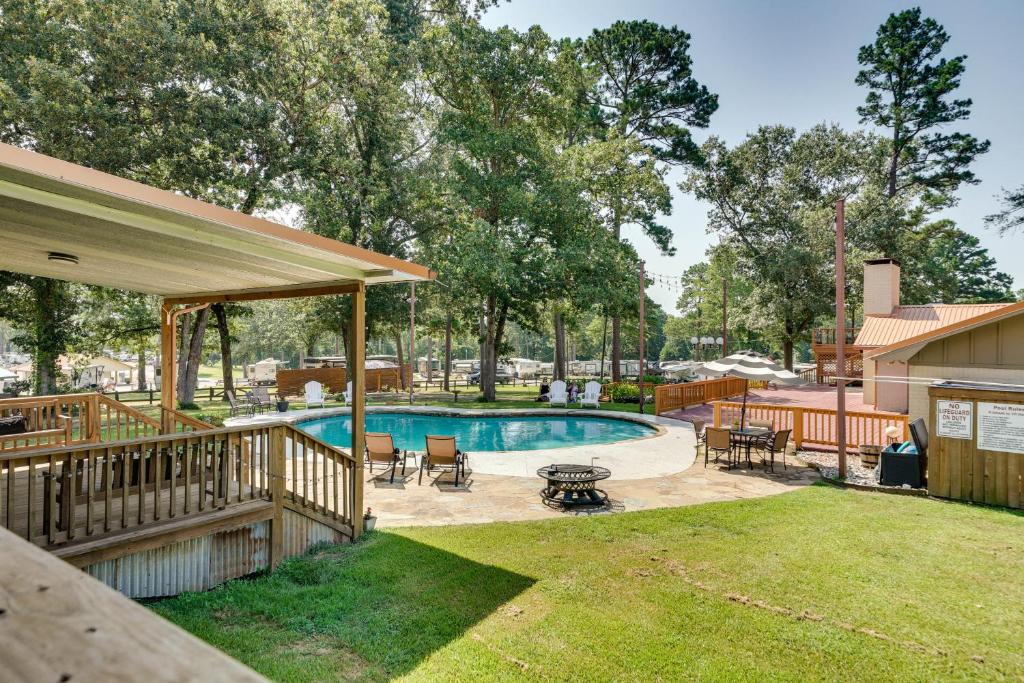 a backyard with a swimming pool and a deck at Charming Texarkana Home Lake and Pool Access! in Texarkana